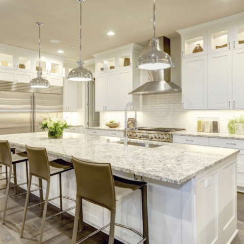 Luxury kitchen with marble countertops, bar seating and custom lighting inspiration