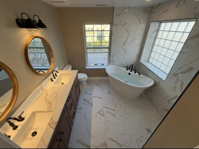 Luxury marble bathroom remodel with freestanding tub and double vanity in Chesapeake Virginia