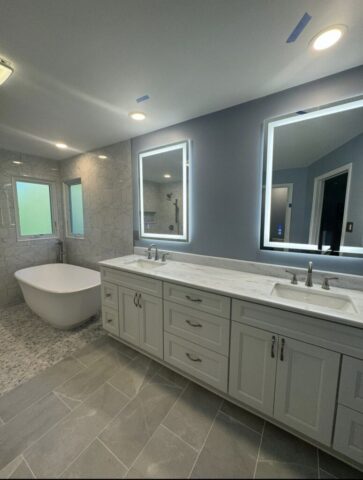 Modern gray bathroom remodel with double vanity and freestanding tub in Virginia Beach VA