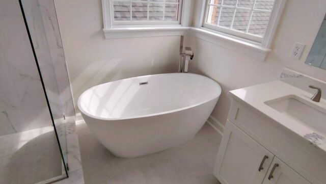 Modern freestanding bathtub next to window in Chesapeake Virginia bathroom remodel