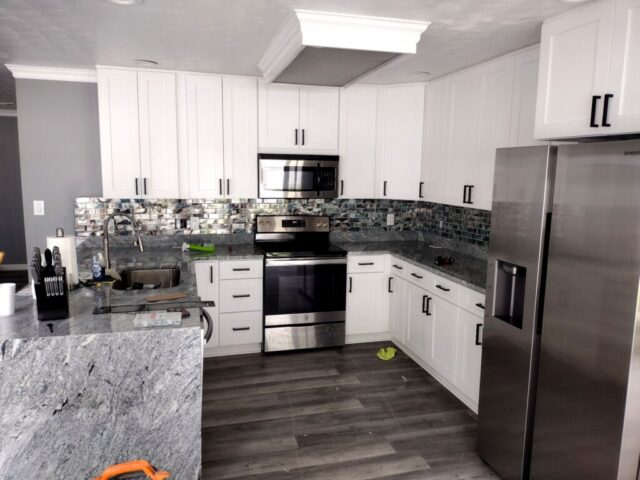 White shaker kitchen cabinets with quartz countertops and stainless steel appliances in Virginia Beach VA kitchen renovation