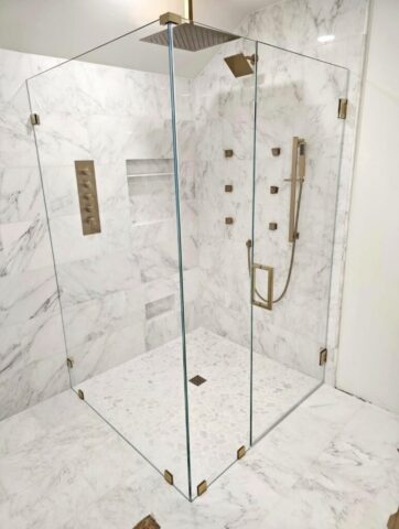Frameless glass shower with marble tile installed in Chesapeake Virginia